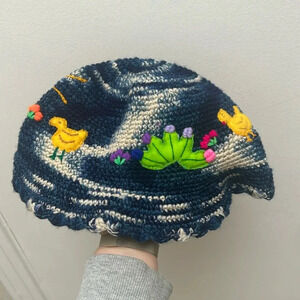 Peruvian hand knit wool bucket  hat with appliqué embroidery, blue and white